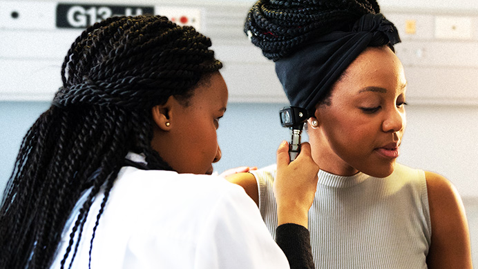 A doctor checking a patient’s ear