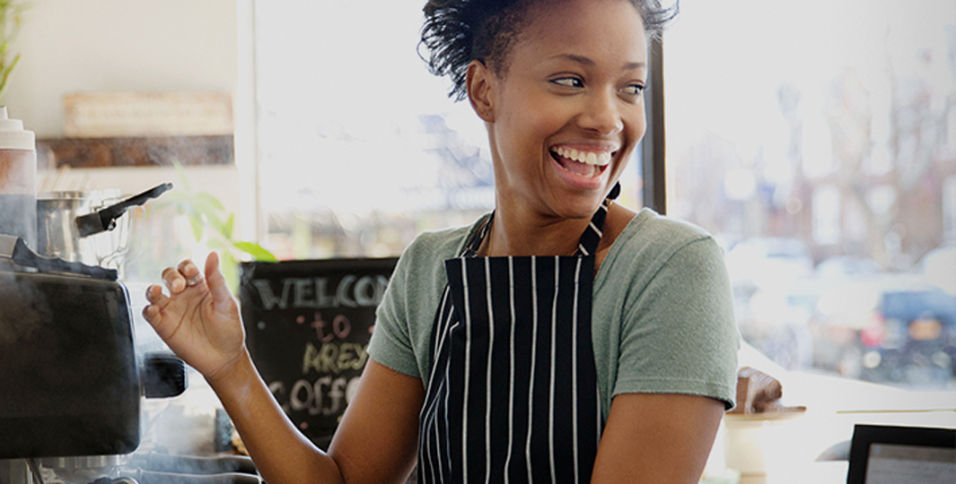a smiling young barista