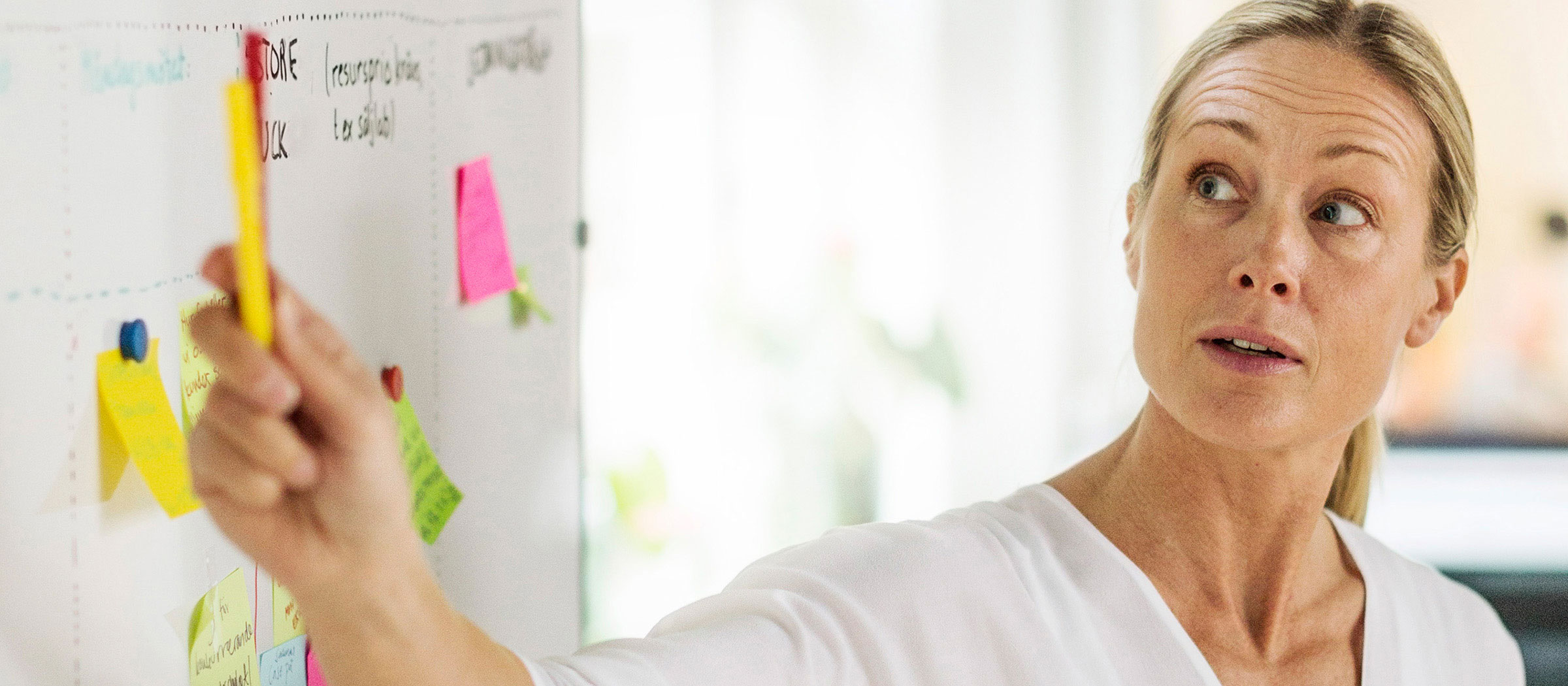 Woman pointing to a whiteboard