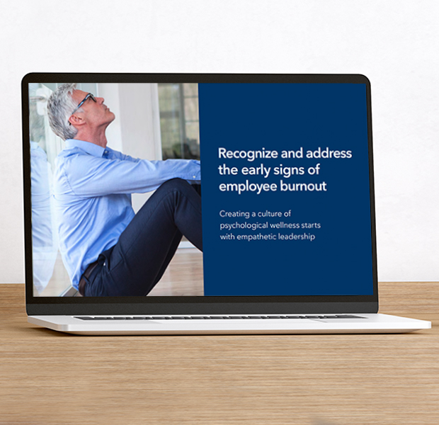 Laptop showing a person leaning against an office wall with adjacent text which reads Recognize and address the early signs of employee burnout